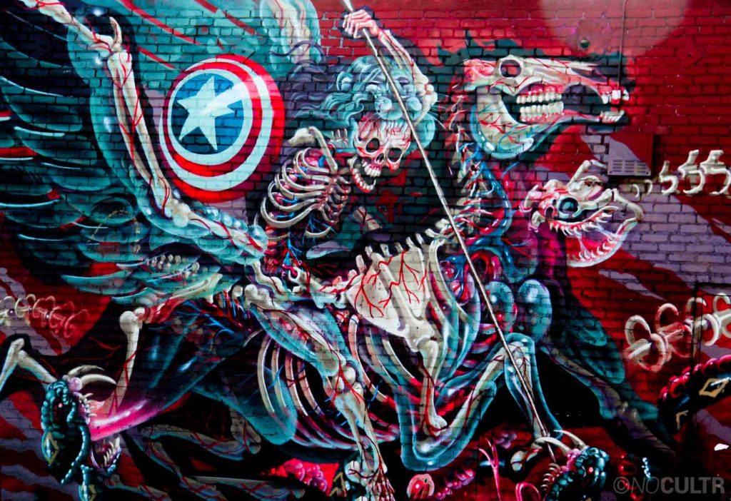 Nychos with a brilliant composition Downtown at The Container Yard. The masterpiece titled, “Captain Hercules Fighting Hydra,” shows an intricate skeletal warrior fighting off the Greek serpent with his Captain America-esque shield. Nychos is the founder of Rabbit Eye...
